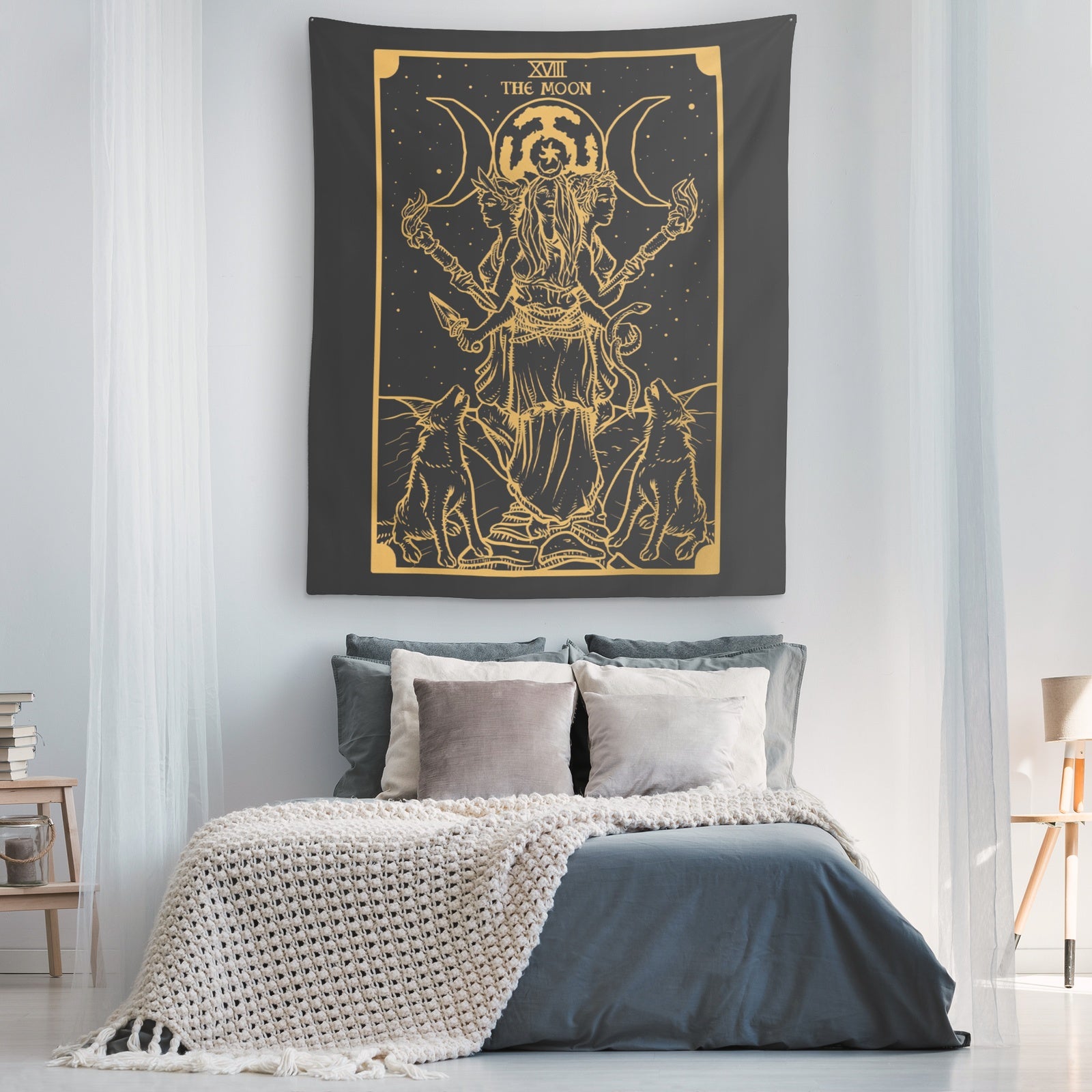 Triple Moon Goddess Hekate Tapestry dark gray with gold line art of Hekate with three moons and two dogs hanging above bed