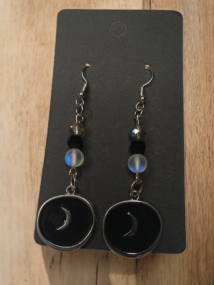 Sacred Moon Candle Co moon medallion earrings with black circular pendant and moon design