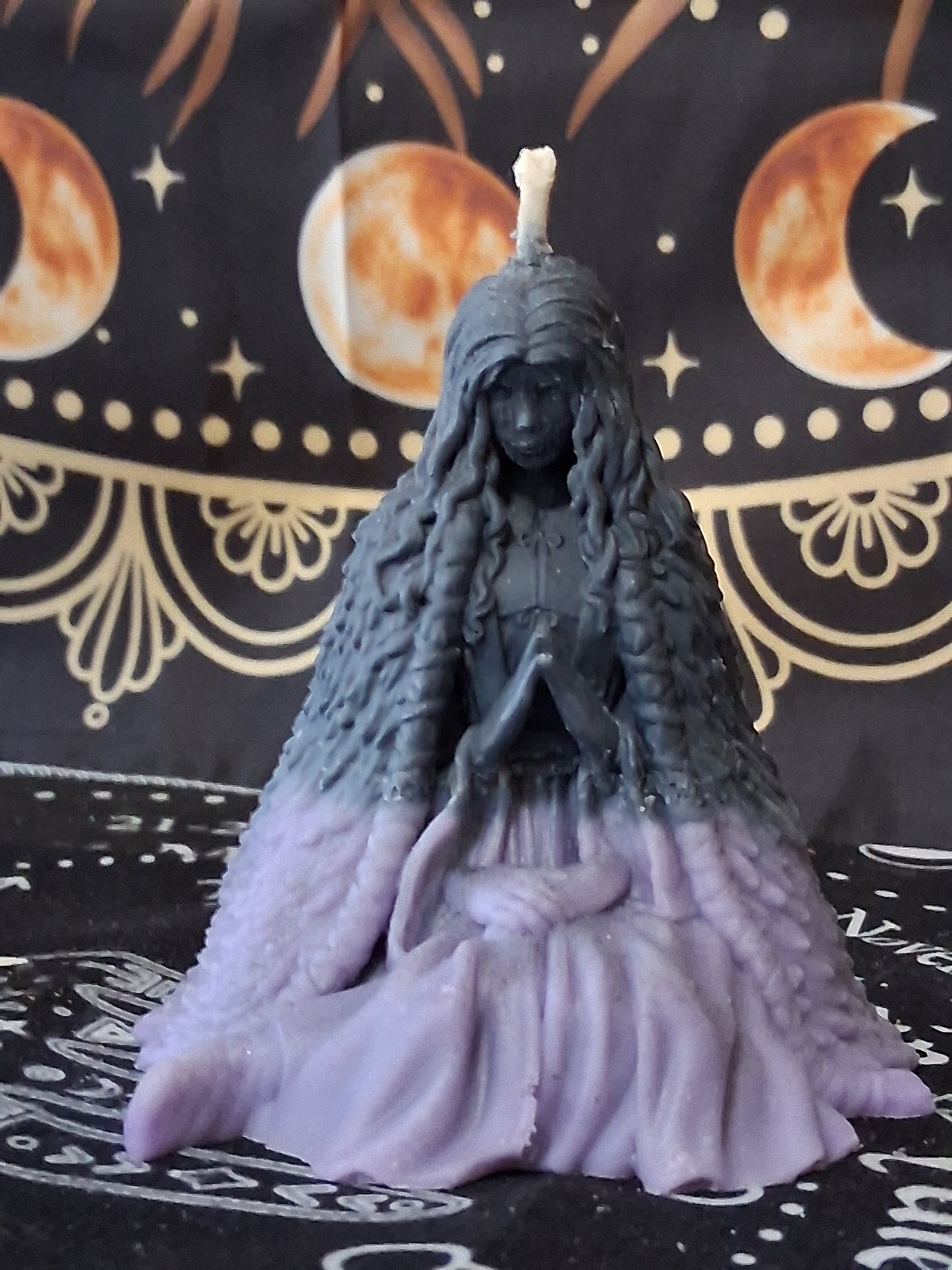 Sacred Moon Candle Co moon water bloom goddess ritual candle in purple and black with intricate figure design