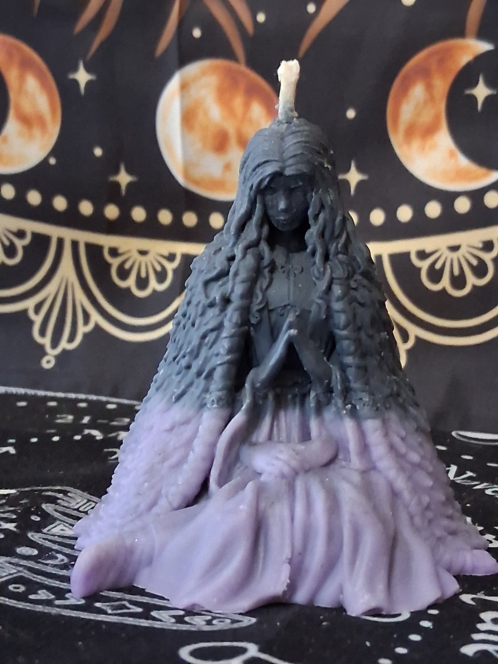 Moon water bloom goddess ritual candle by Sacred Moon Candle Co shaped like a seated goddess with flowing hair and robes