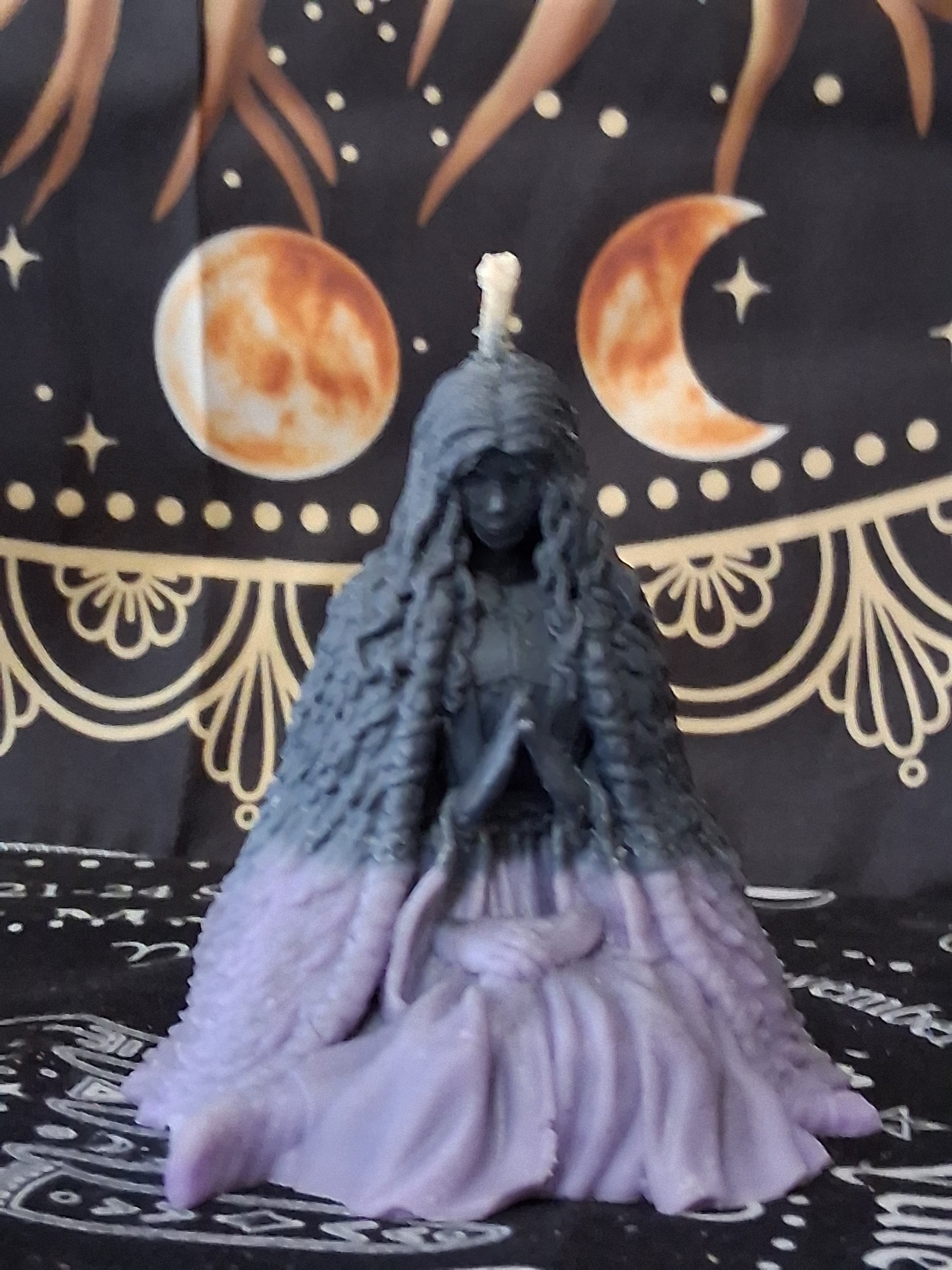 Sacred Moon Candle Co moon water bloom goddess ritual candle shaped like a seated goddess in black and purple