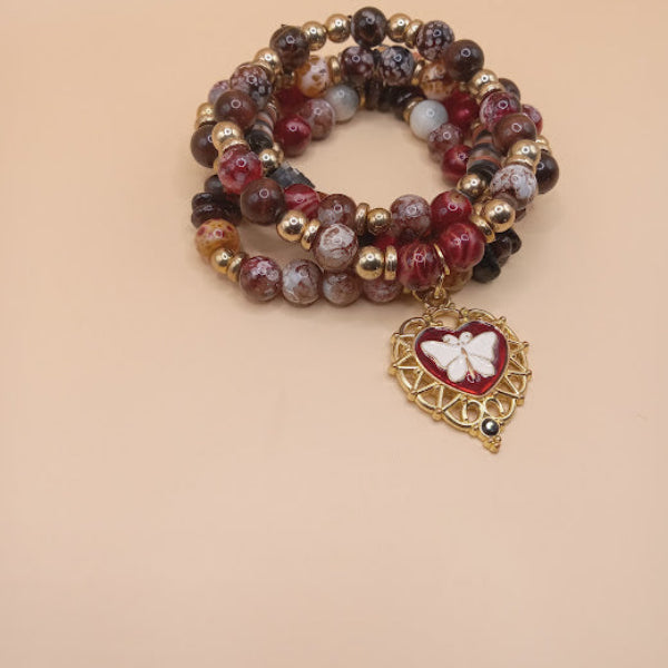Moth and flame bracelet stack by Sacred Moon Candle Co featuring red and brown beaded bracelets with gold accents and a moth charm