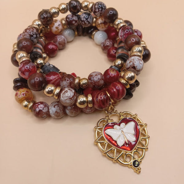 Moth and flame bracelet stack by Sacred Moon Candle Co featuring red and brown beads with gold accents and a heart charm