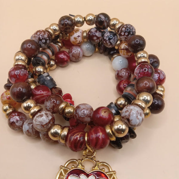 Moth and flame bracelet stack by Sacred Moon Candle Co featuring multicolor beads and gold accents