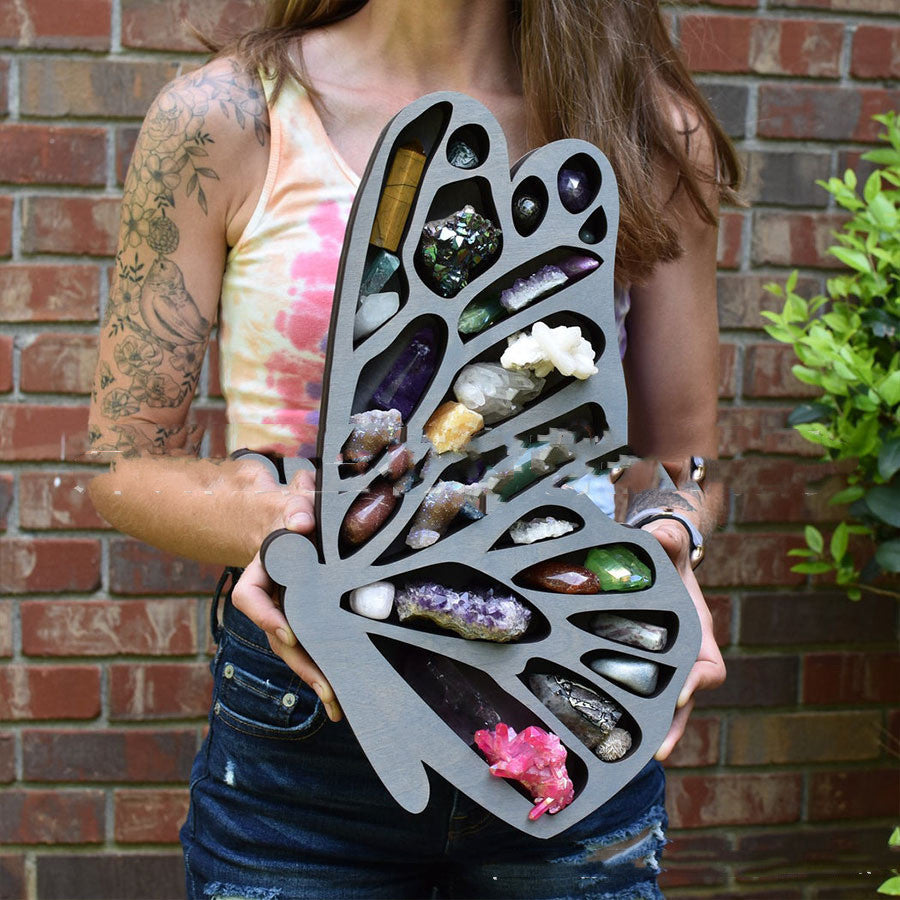 Woman holding Moon, Fairy, Butterfly Shelves wooden butterfly wing display filled with crystals and geodes