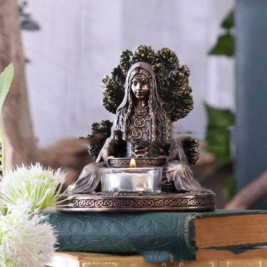 Sacred Moon Candle Co Celtic Goddess Danu tealight altar decor bronze statue with lit tealight on books