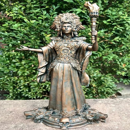 Hekate goddess statue bronze finish ornate headdress holding torch and outstretched hand on skull base