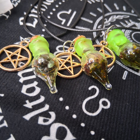 Prosperity spell bottle necklace with green glass vial and pentagram charm on black cord