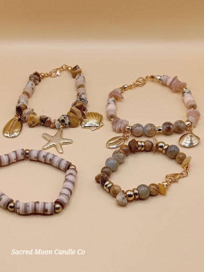 Bohemian natural stone bracelet stack featuring earthy tones and gold shell and starfish charms