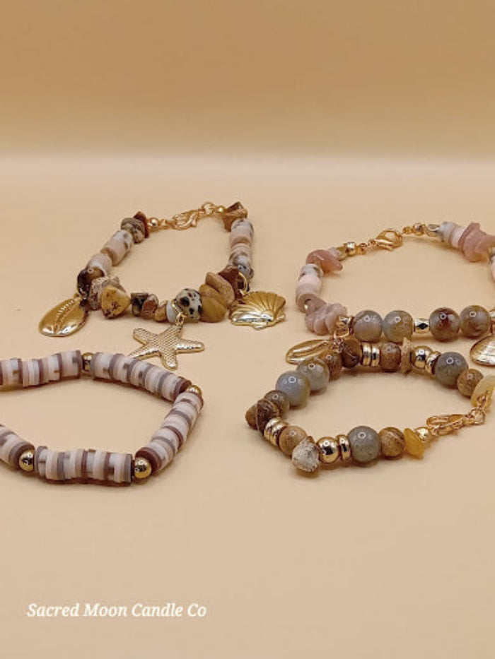 Bohemian natural stone bracelet stack by Sacred Moon Candle Co featuring earthy tones and gold charms
