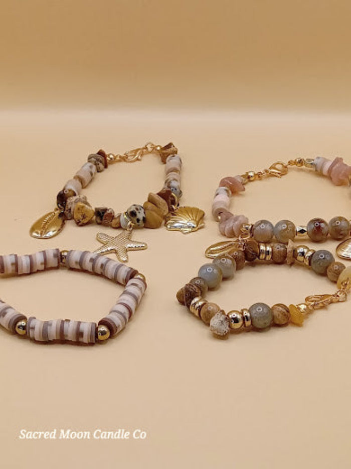 Bohemian natural stone bracelet stack with gold shell and star charms from Sacred Moon Candle Co