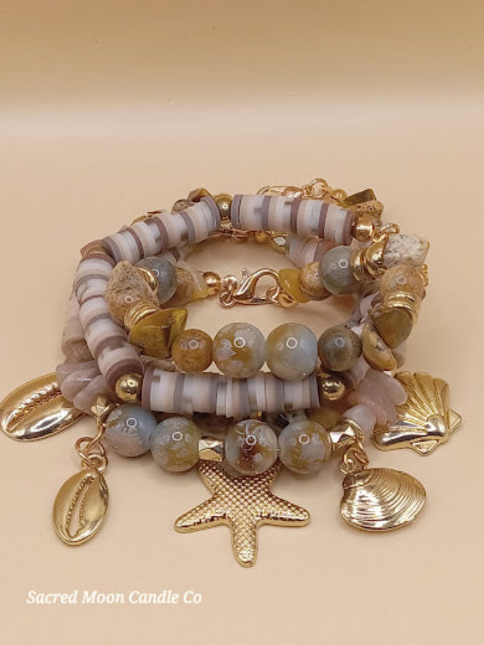 Bohemian natural stone bracelet stack with gold seashell charms from Sacred Moon Candle Co