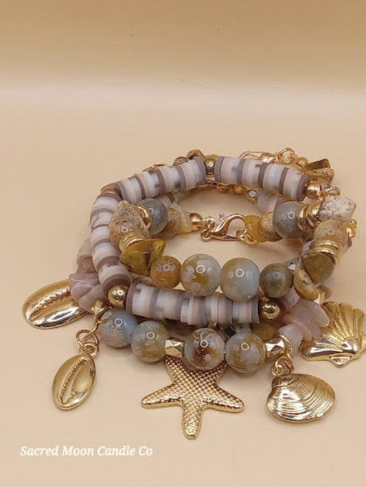 Bohemian natural stone bracelet stack with gold starfish and shell charms by Sacred Moon Candle Co