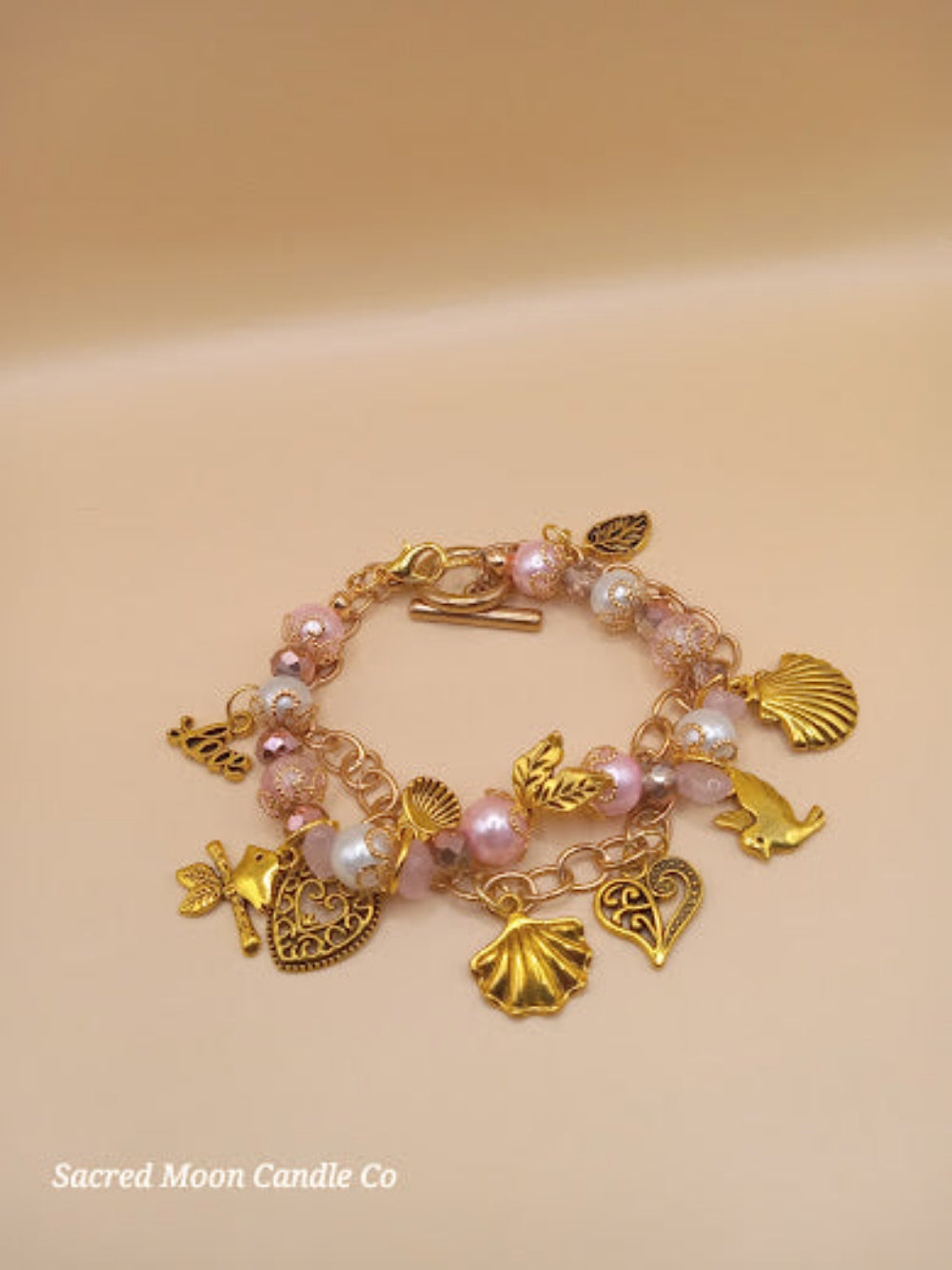 Sacred Moon Candle Co Aphrodite bracelet set with gold charms and pink pearl beads bracelet stack