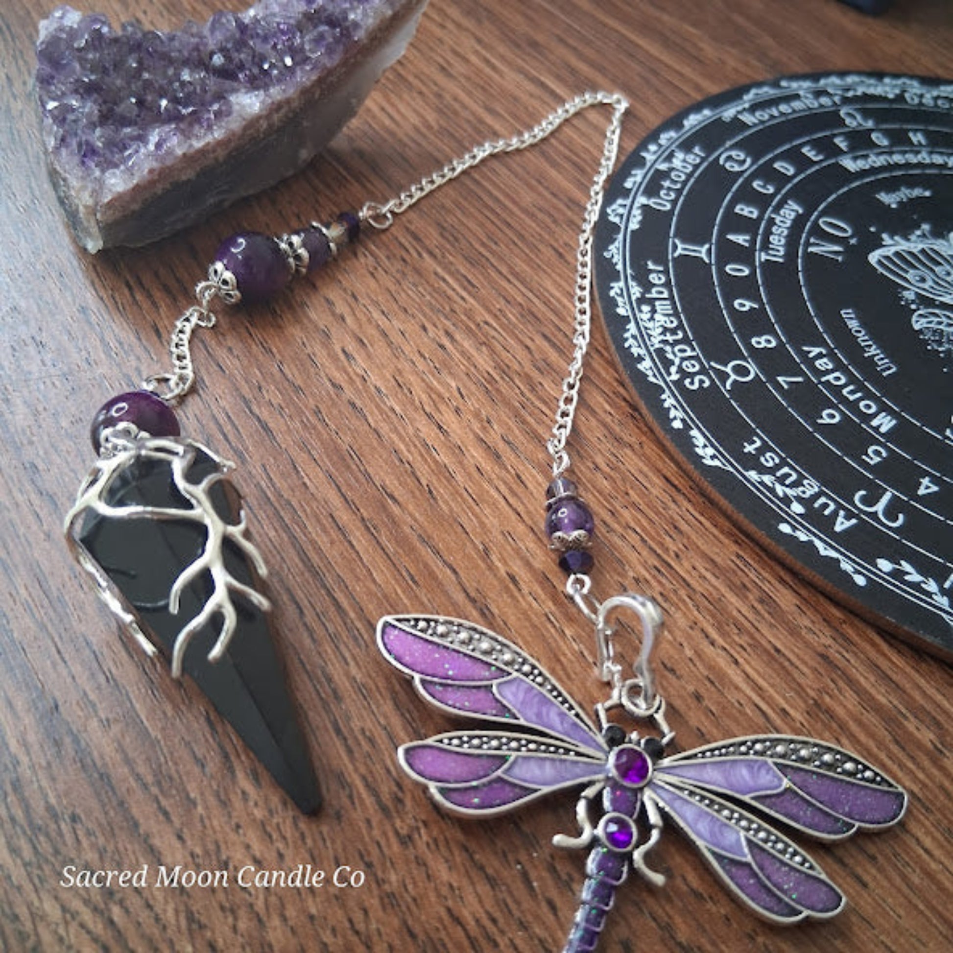 Black tourmaline Purple Tigers Eye Dragonfly Pendulum altar tool with amethyst beads on wooden surface