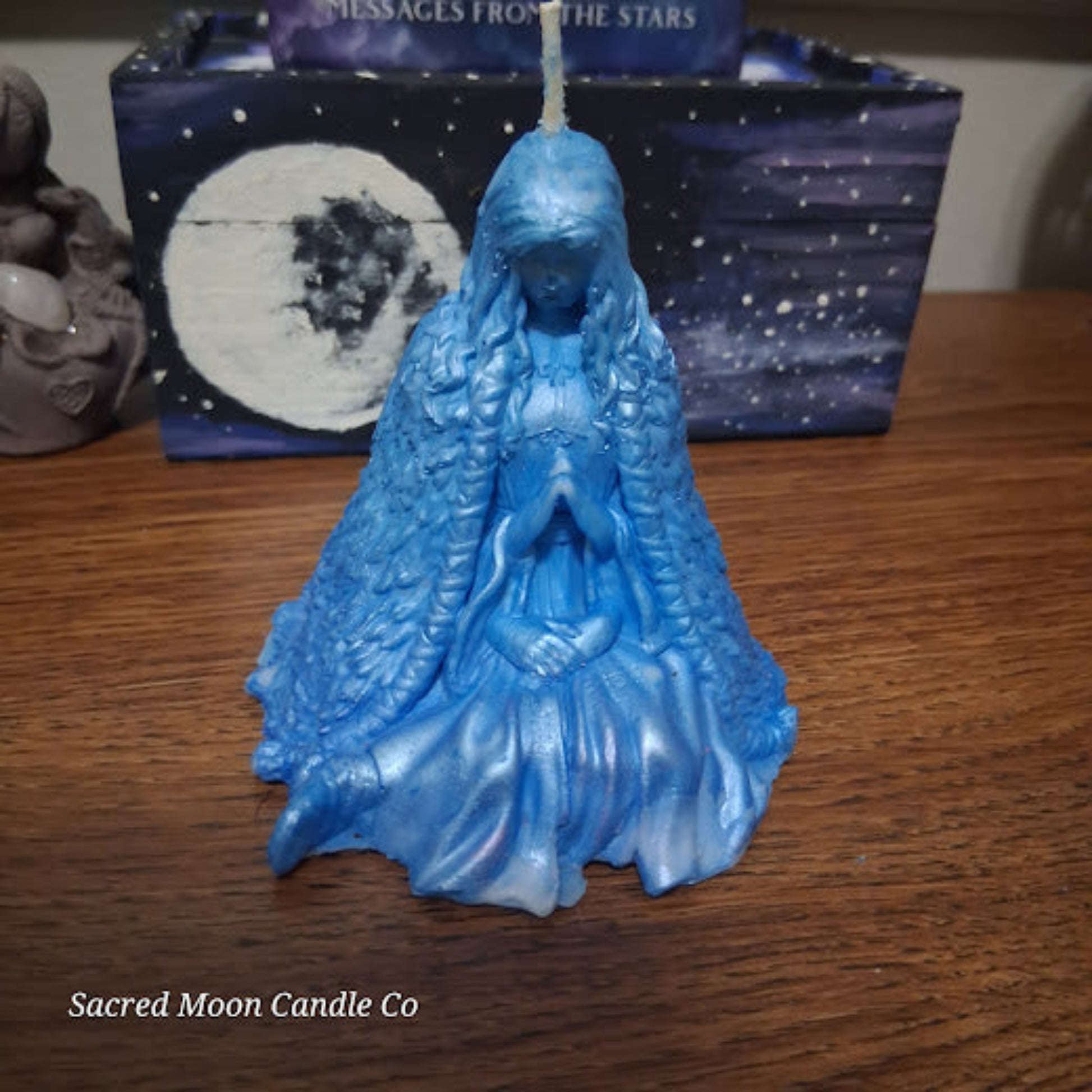 Blue Whispering Water Lily Goddess Candle 3.3oz . Goddess shaped blue candle with detailed flowing cloak and praying hands