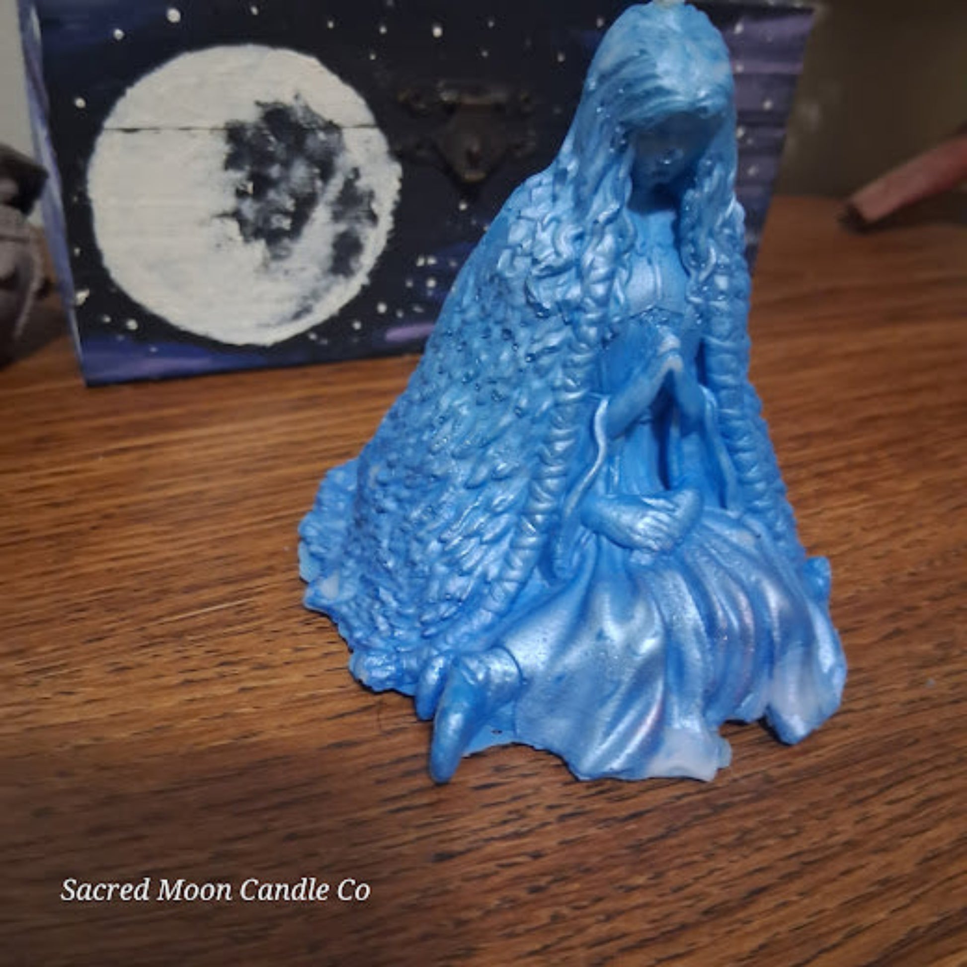 Blue Whispering Water Lily Goddess Candle 3.3oz . Sacred Moon Candle Co blue goddess candle on wood with moon art