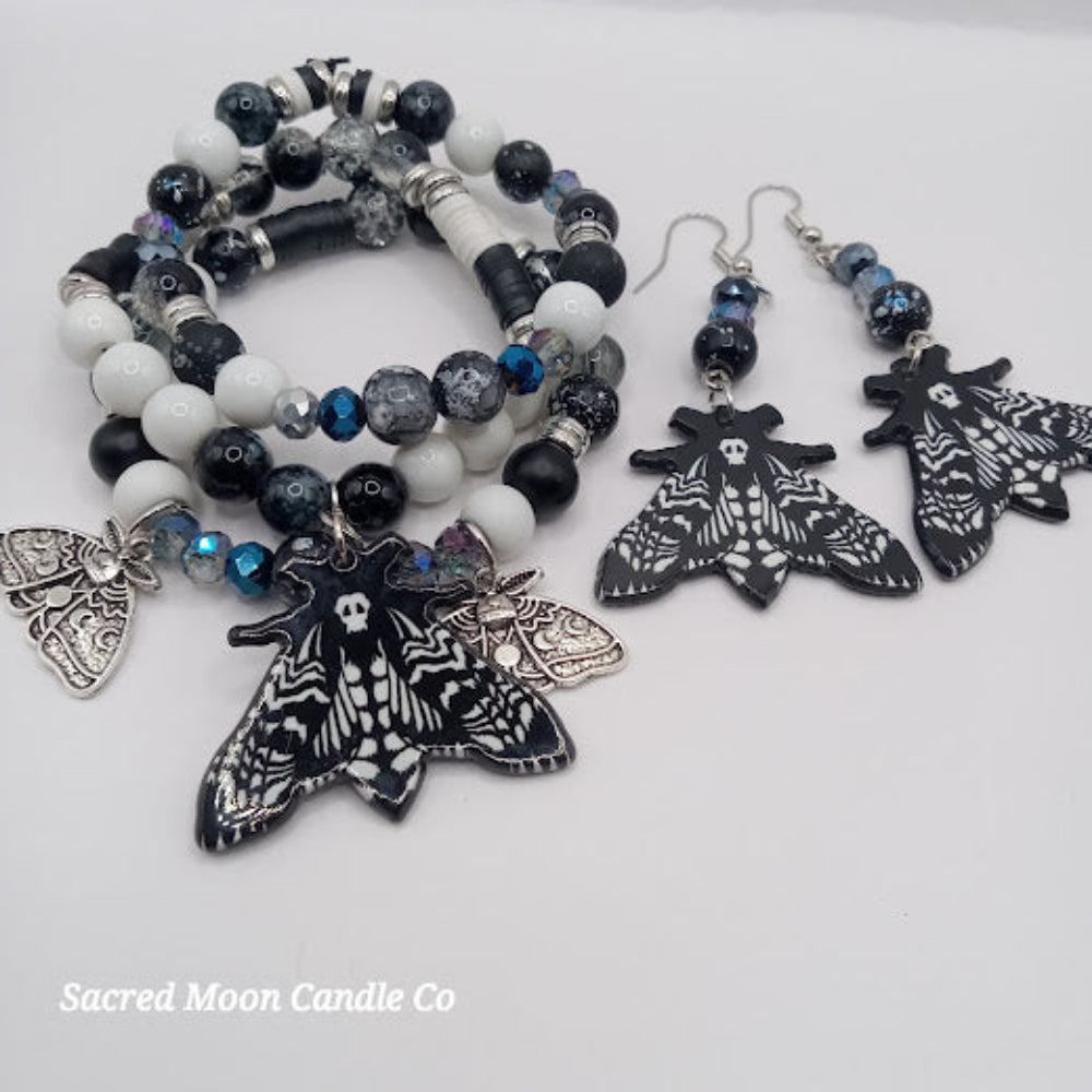 Lunar moth jewelry set with black and white beaded bracelet and matching moth earrings by Sacred Moon Candle Co