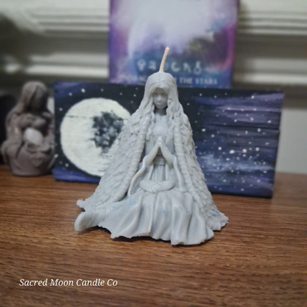 Mother Earth goddess candle by Sacred Moon Candle Co white sculpted goddess in meditative pose with braided hair and cloak