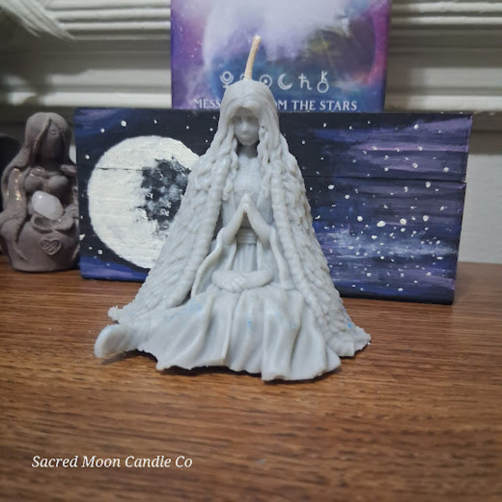 Mother Earth goddess candle by Sacred Moon Candle Co white seated goddess with braided hair and prayer hands