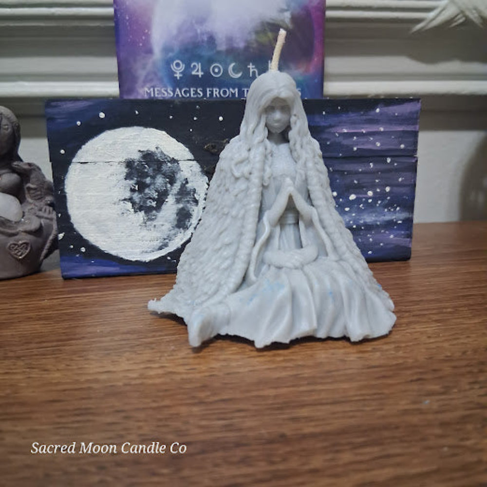 Sacred Moon Candle Co Mother Earth goddess candle white seated goddess figure with long hair and moon backdrop