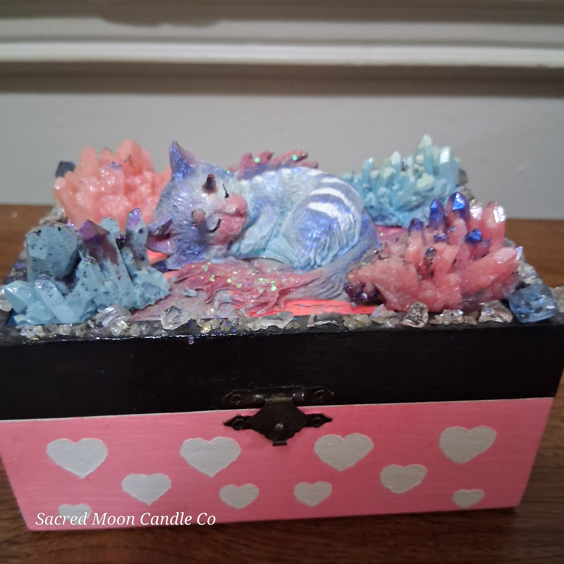 Pastel sleeping cat dragon sculpture amid pink and blue crystals on a pink heart box mystical cat dragon apothecary box