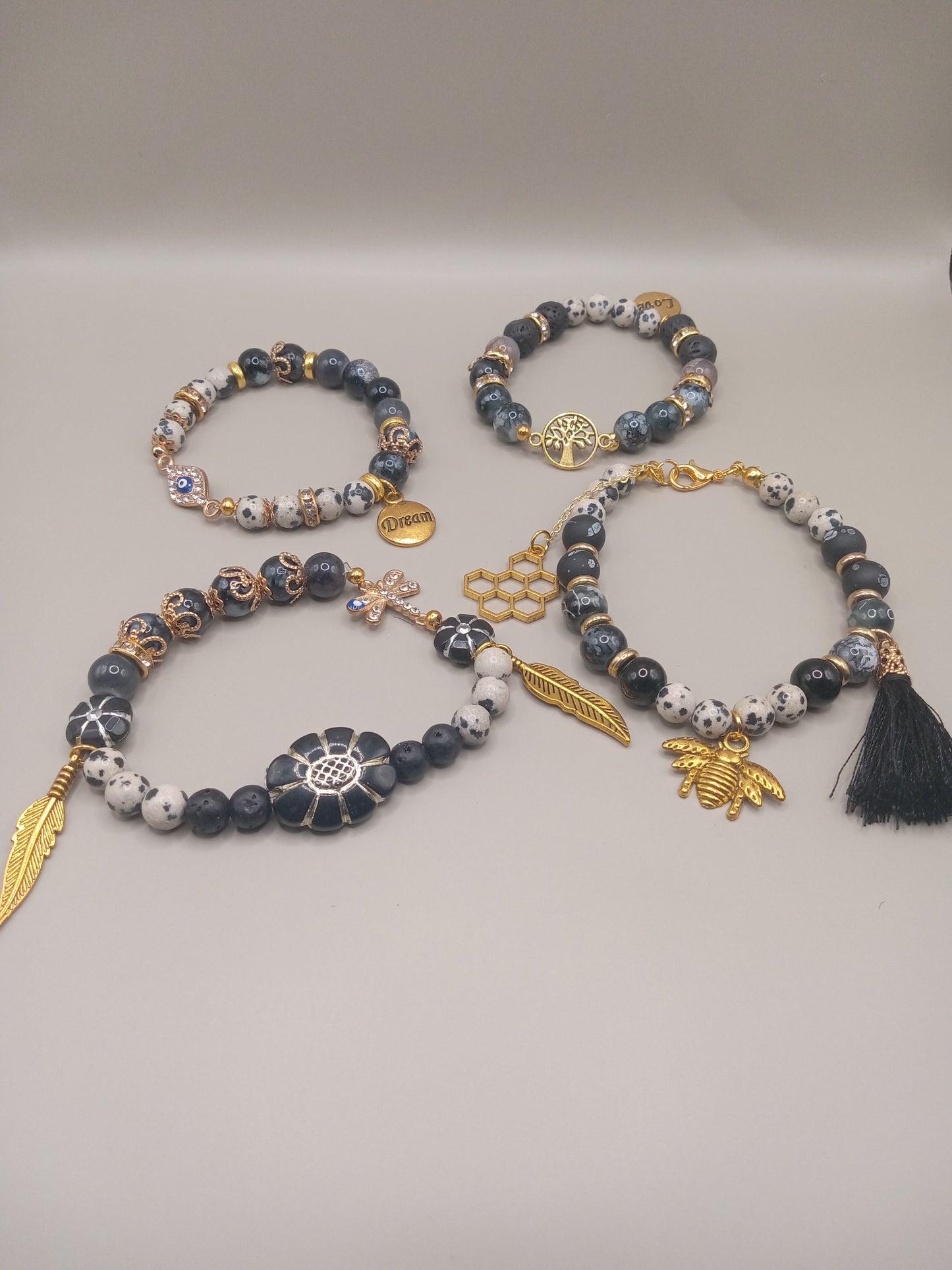 One with Nature Bohemian Dalmatian Jasper Bracelet Stack by Sacred Moon Candle Co gold charms feather bee tassel