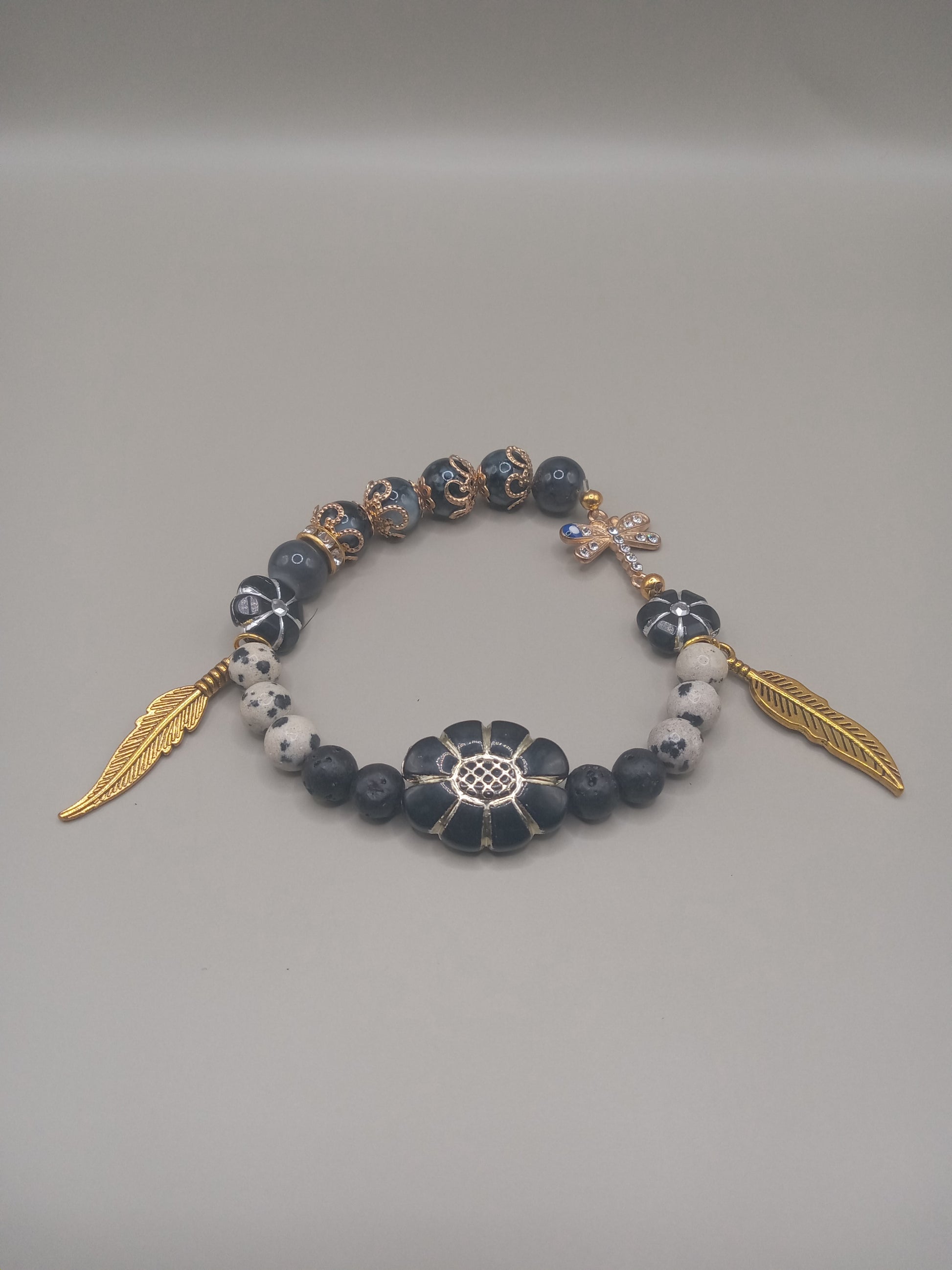 Sacred Moon Candle Co One with Nature Bohemian Dalmatian Jasper Bracelet Stack with gold feather charms and spotted jasper beads