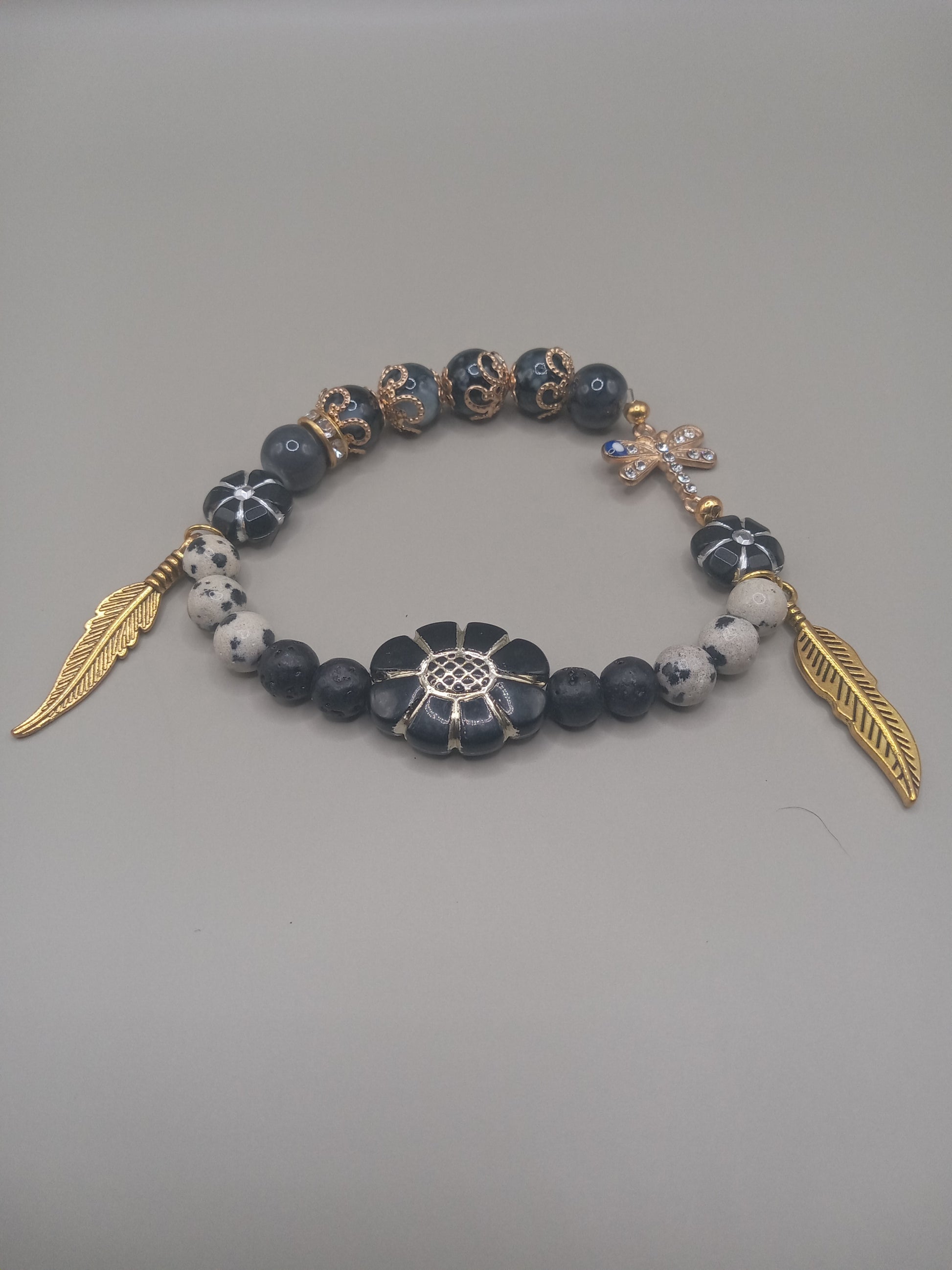One with Nature Bohemian Dalmatian Jasper Bracelet Stack with gold feather charms floral center and mixed black beads