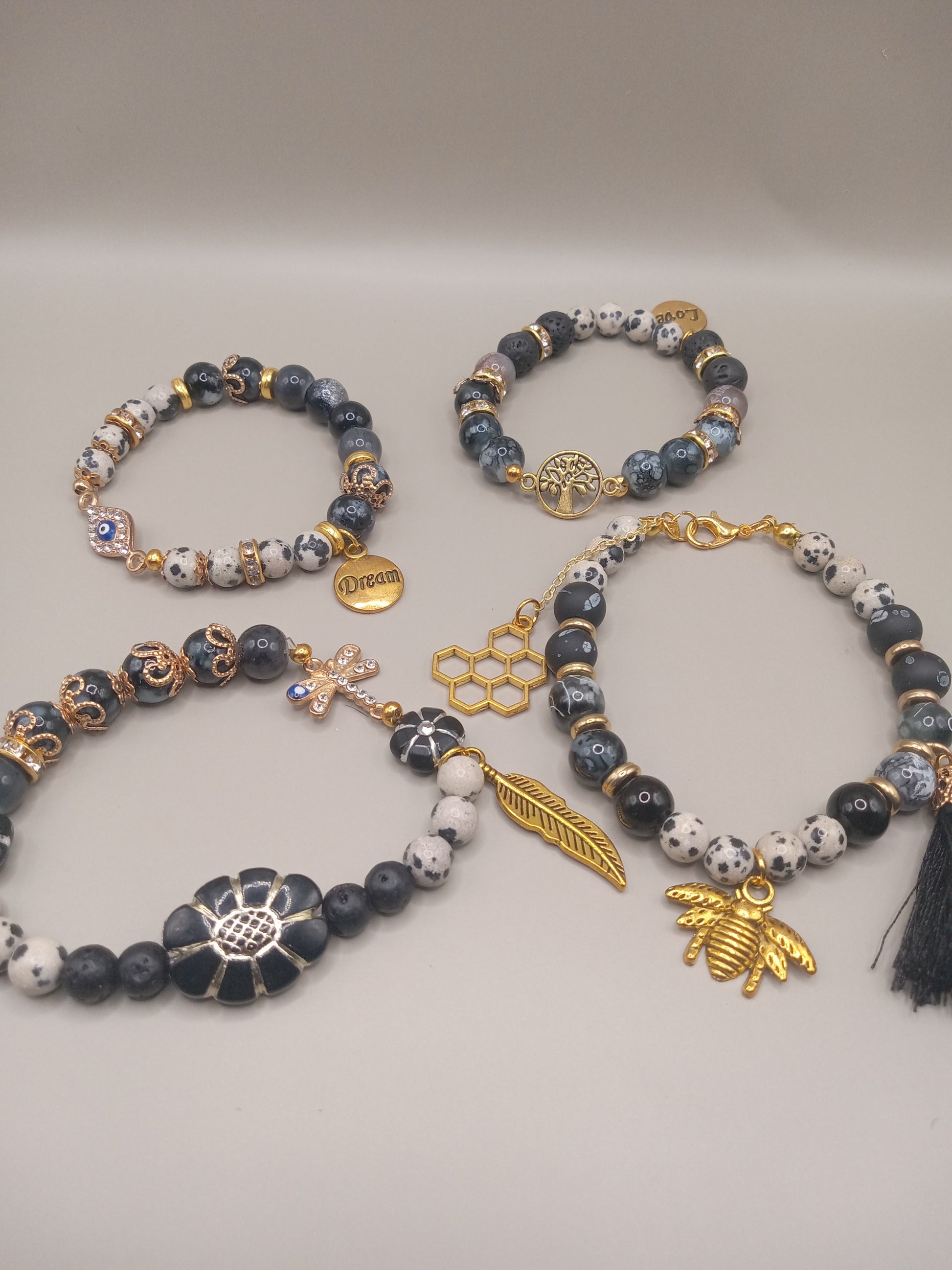 One with Nature Bohemian Dalmatian Jasper Bracelet Stack set with spotted jasper beads and gold bee feather tassel charms