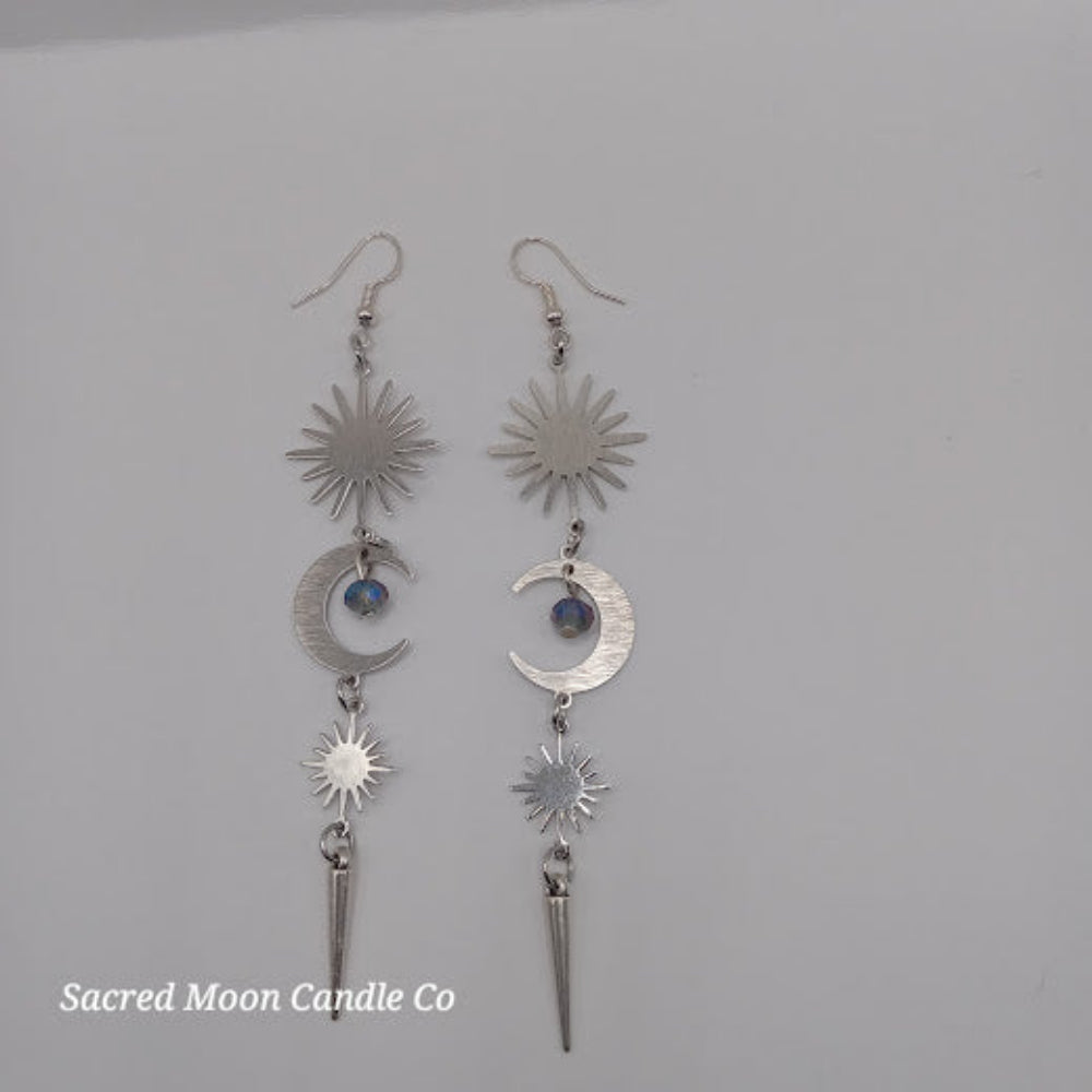 Silver spiked moon dangle earrings with sun and crescent moon charms from Sacred Moon Candle Co