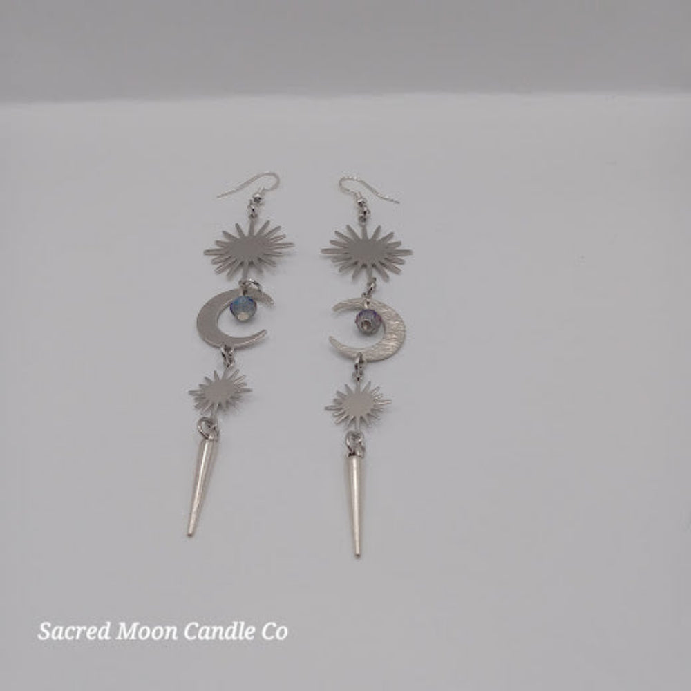 Sacred Moon Candle Co spiked moon dangle earrings with silver stars, crescent moons, and spike charms