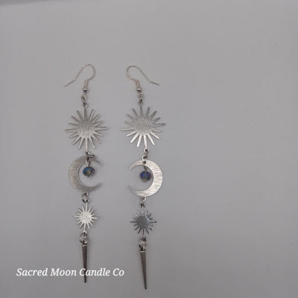 Sacred Moon Candle Co silver spiked moon dangle earrings featuring sun and moon charms with blue bead accents