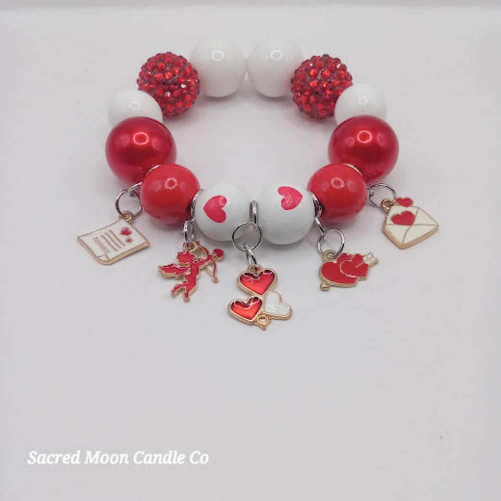 Sacred Moon Candle Co Cupid themed bubblegum beaded bracelet with red white beads and love charms