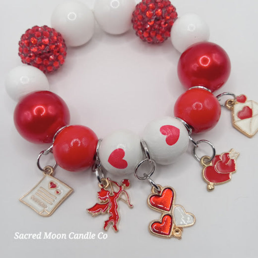 Cupid themed bubblegum beaded bracelet with red white beads and heart cupid charms by Sacred Moon Candle Co