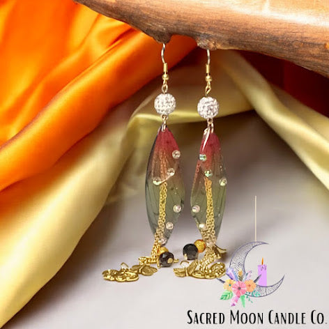 Firefly fairy earrings by Sacred Moon Candle Co featuring delicate wing design with gold chains and crystal accents