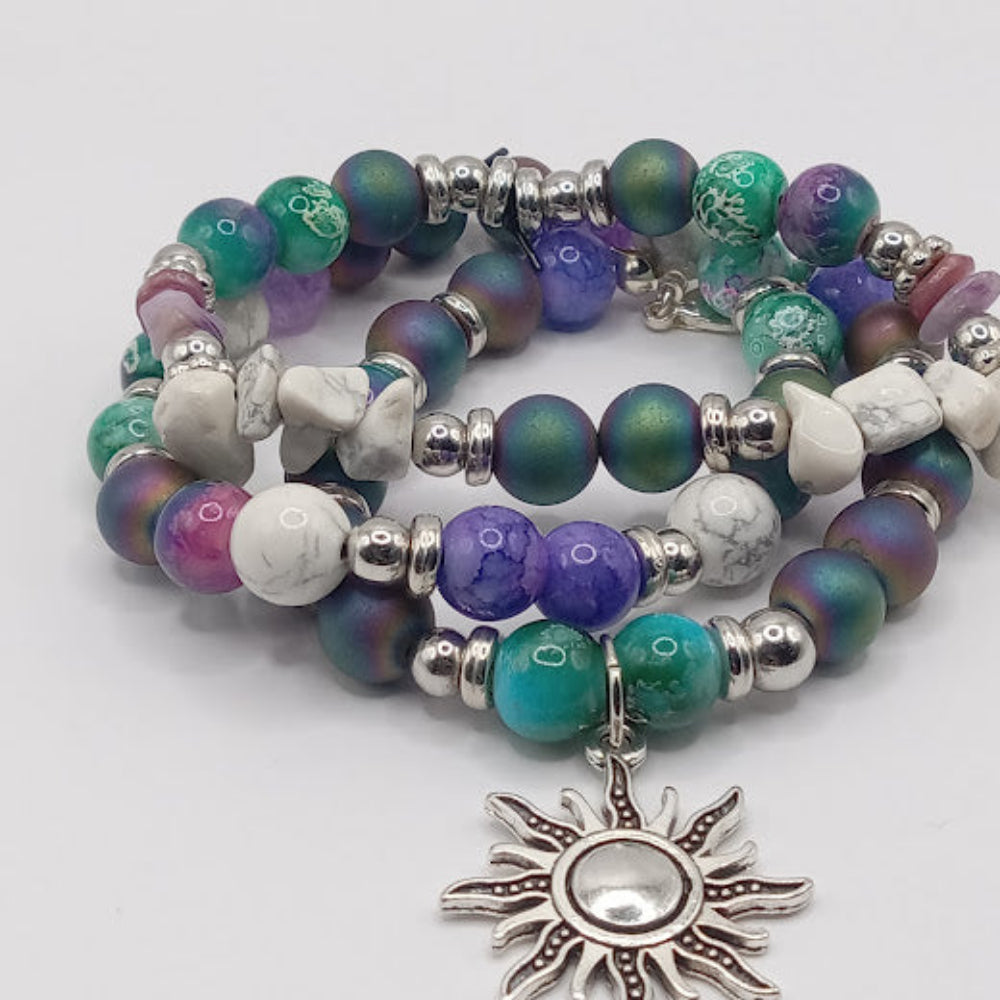 Colorful celestial sun bracelet stack with silver sun charm and multicolor beads by Sacred Moon Candle Co