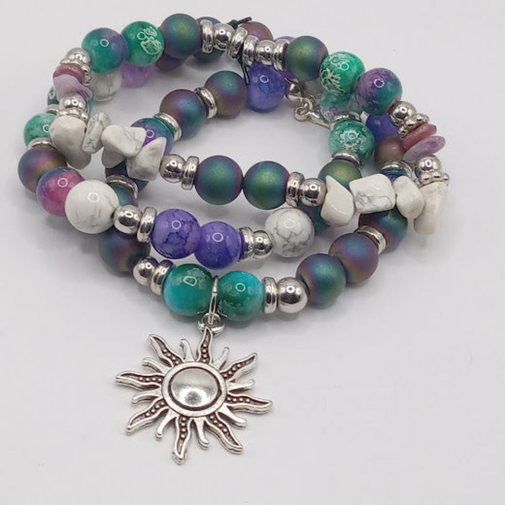 Sacred Moon Candle Co celestial sun bracelet stack with colorful beads and silver sun charm