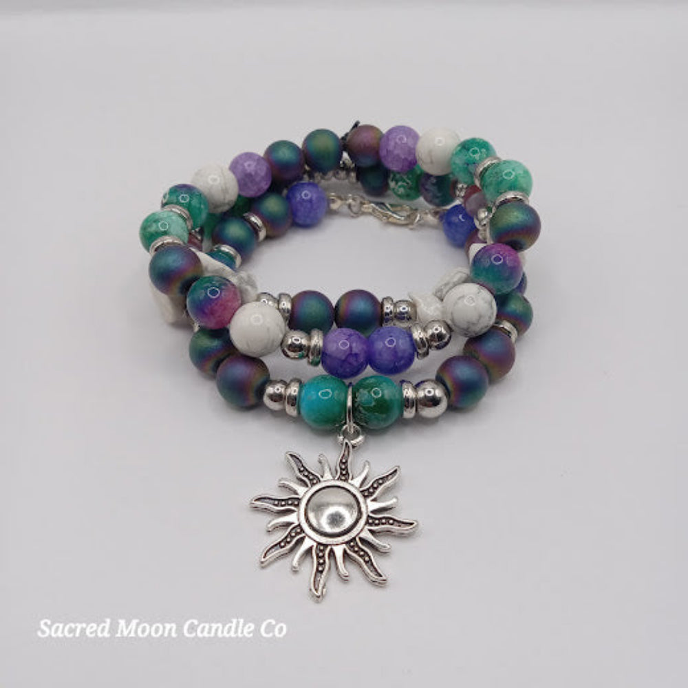 Celestial sun bracelet stack with multicolored beads and silver sun charm by Sacred Moon Candle Co