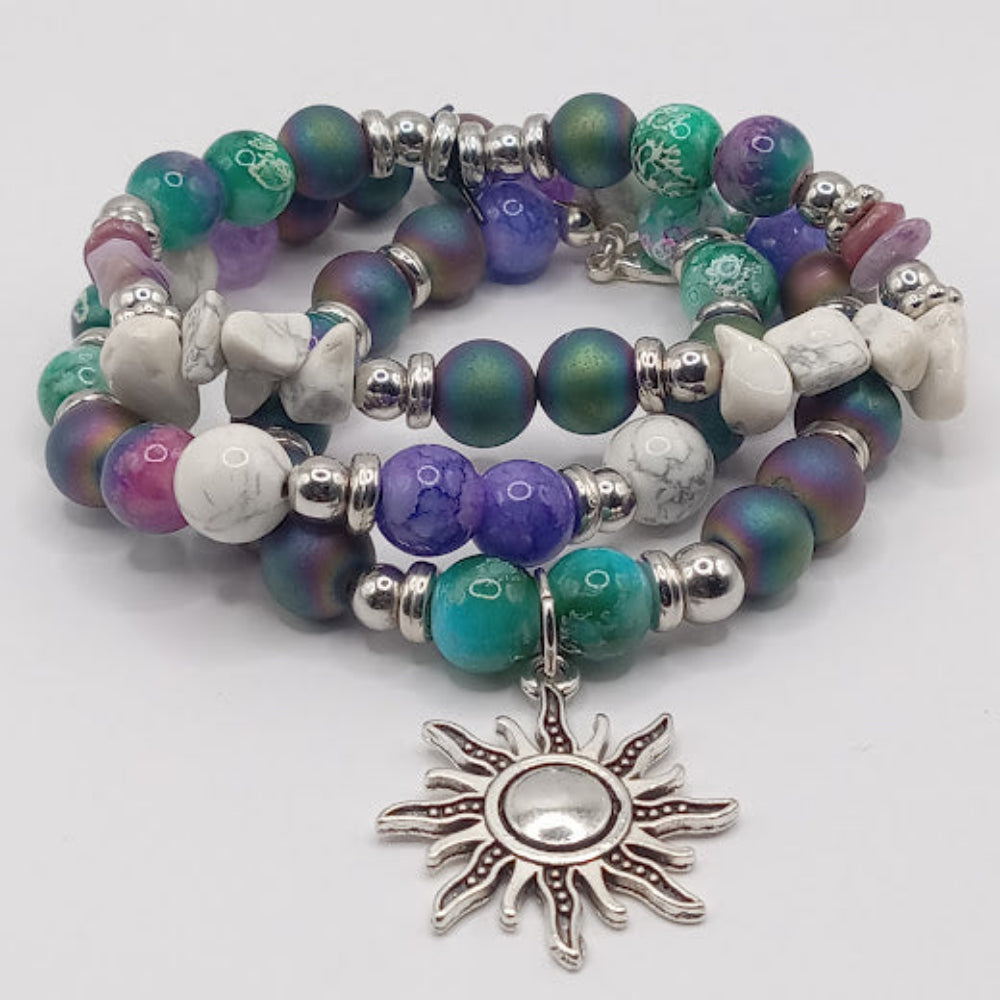 Sacred Moon Candle Co celestial sun bracelet stack with multicolored beads and silver sun charm