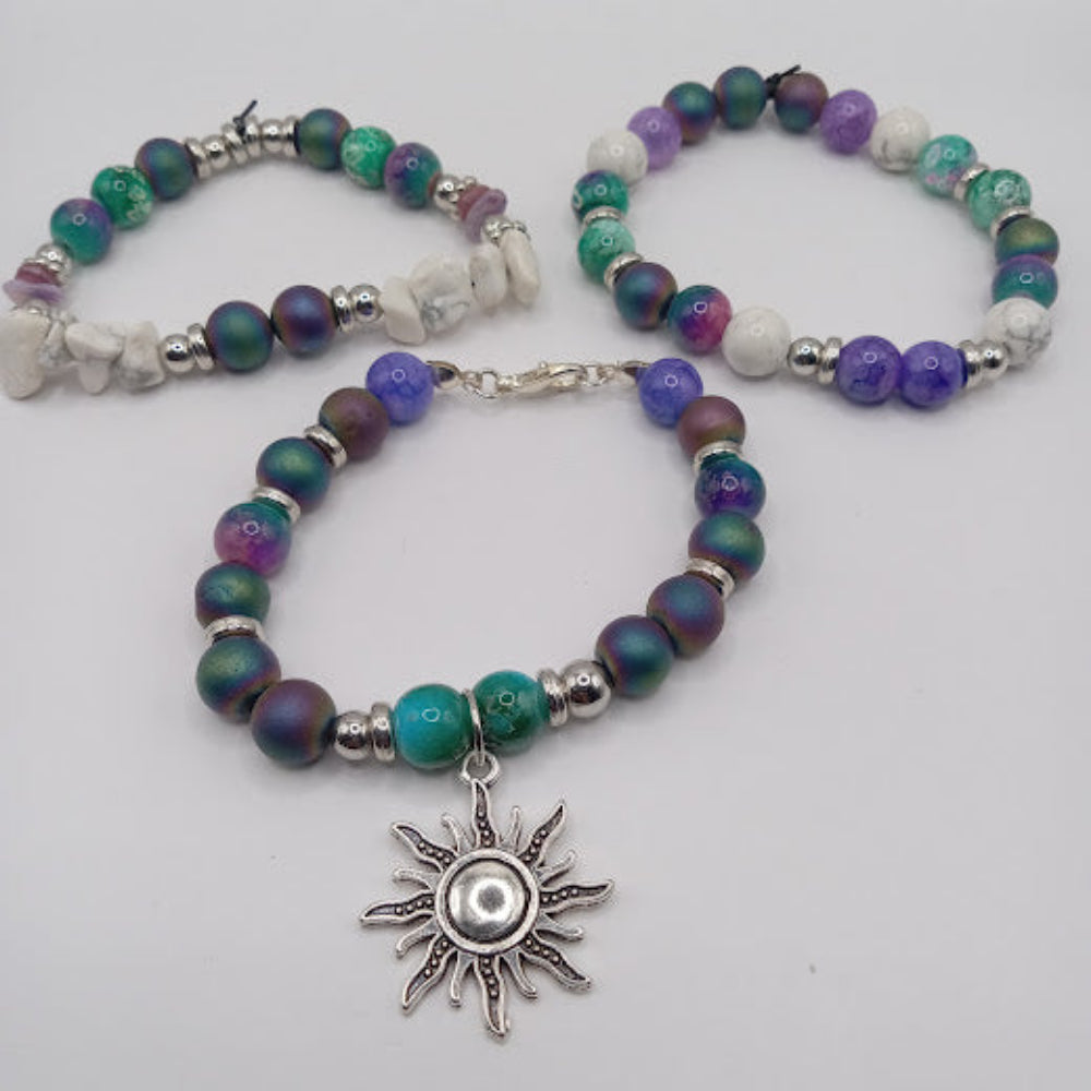 Celestial sun bracelet stack by Sacred Moon Candle Co featuring beaded bracelets with silver sun charm