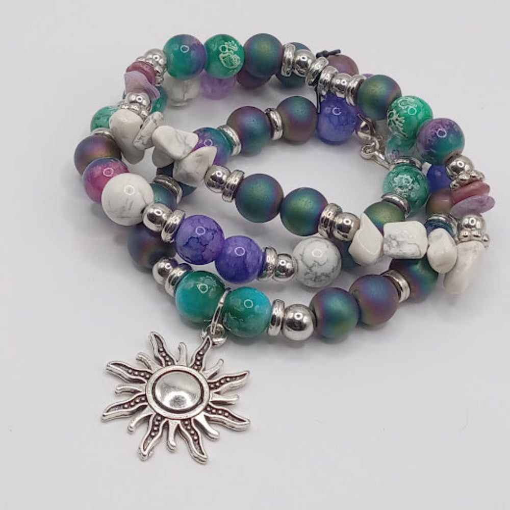 Celestial sun bracelet stack with colorful beads and silver sun charm by Sacred Moon Candle Co