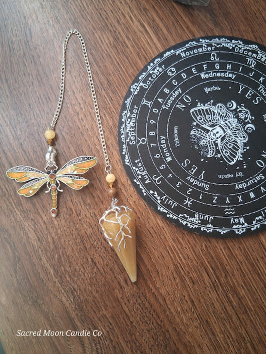 Golden healer quartz pendulum with dragonfly charm and wooden beads from Sacred Moon Candle Co altar tools