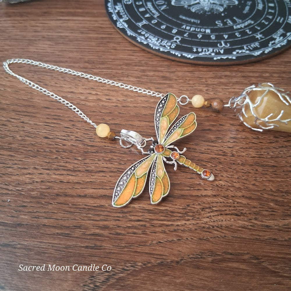 Golden healer quartz pendulum with decorative dragonfly charm on silver chain by Sacred Moon Candle Co