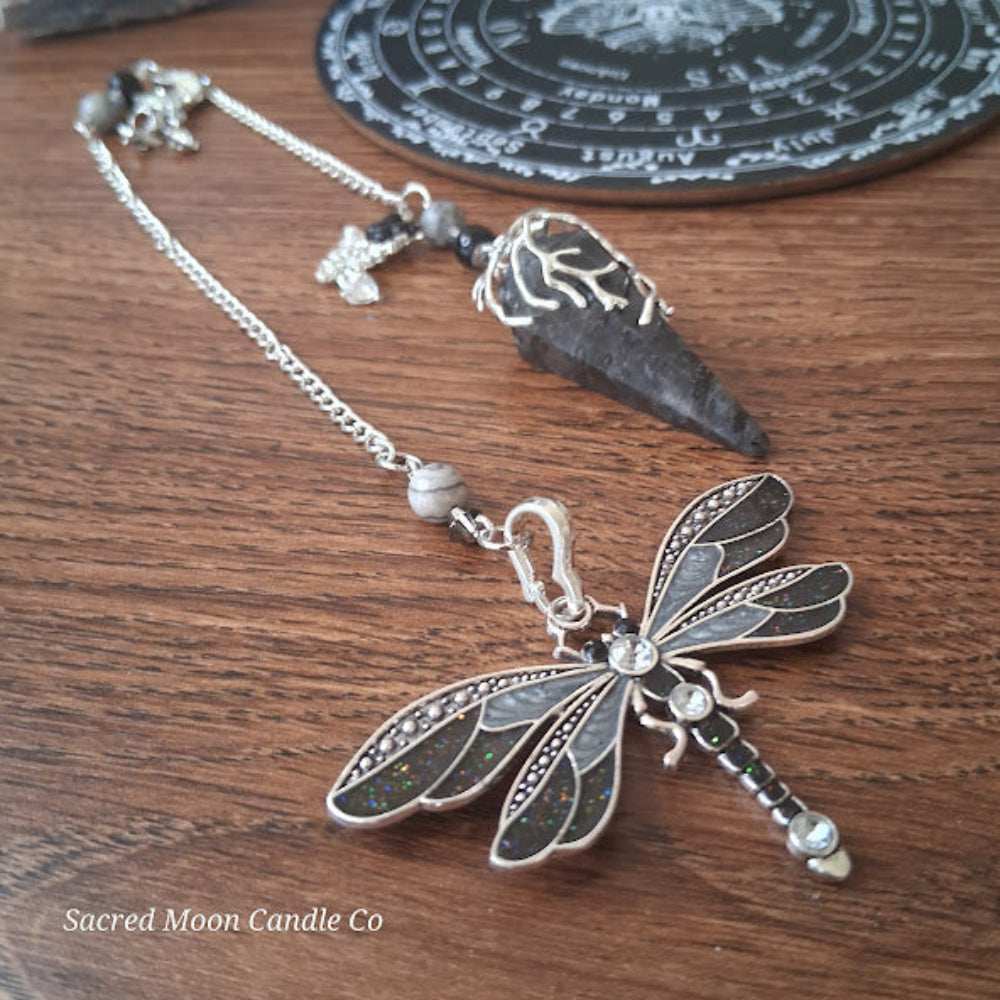 Larvikite moon pendulum with silver dragonfly charm and decorative chain from Sacred Moon Candle Co
