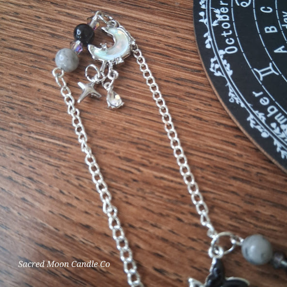 Larvikite moon pendulum altar tool with silver chain and lunar charms by Sacred Moon Candle Co