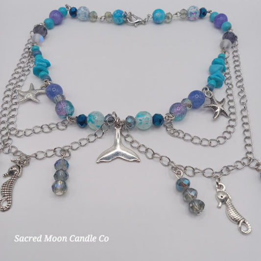 Sacred Moon Candle Co mermaid tail choker necklace with silver charms and blue purple beads