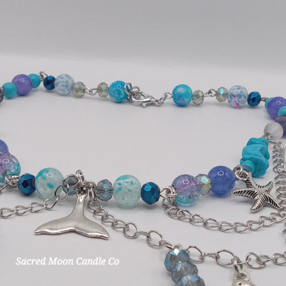 Mermaid tail choker necklace with blue and purple beads and silver charms by Sacred Moon Candle Co