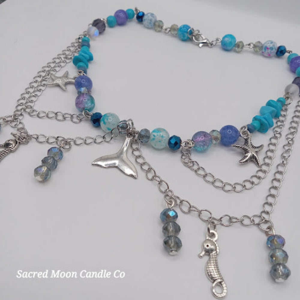 Colorful beaded mermaid tail choker necklace with silver charms including starfish, seahorse, and tail pendant
