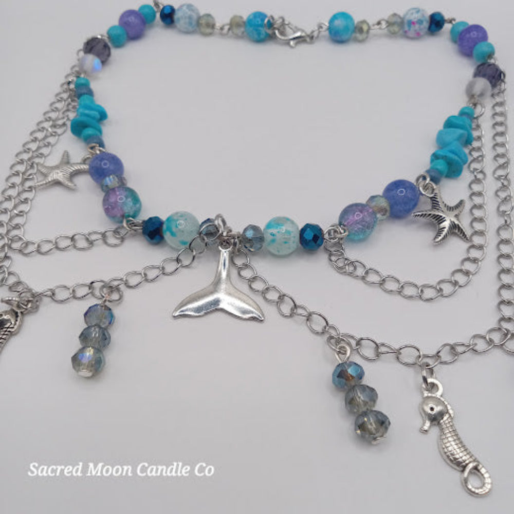 Colorful beaded mermaid tail choker necklace with silver chains, starfish, and seahorse charms